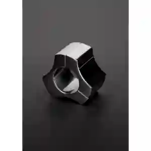 Shiny silver geometric ring with angular facets and a hollow center on a dark surface.