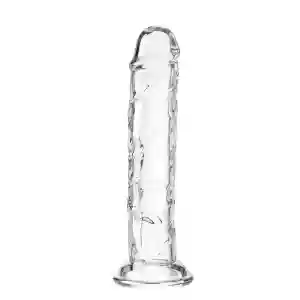 Clear glass dildo with a rounded tip and flared base, standing upright.