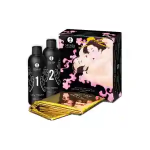 Shunga erotic massage kit with two black bottles labeled 1 and 2, gold foil sachets, and a decorative box showing entwined couple artwork.